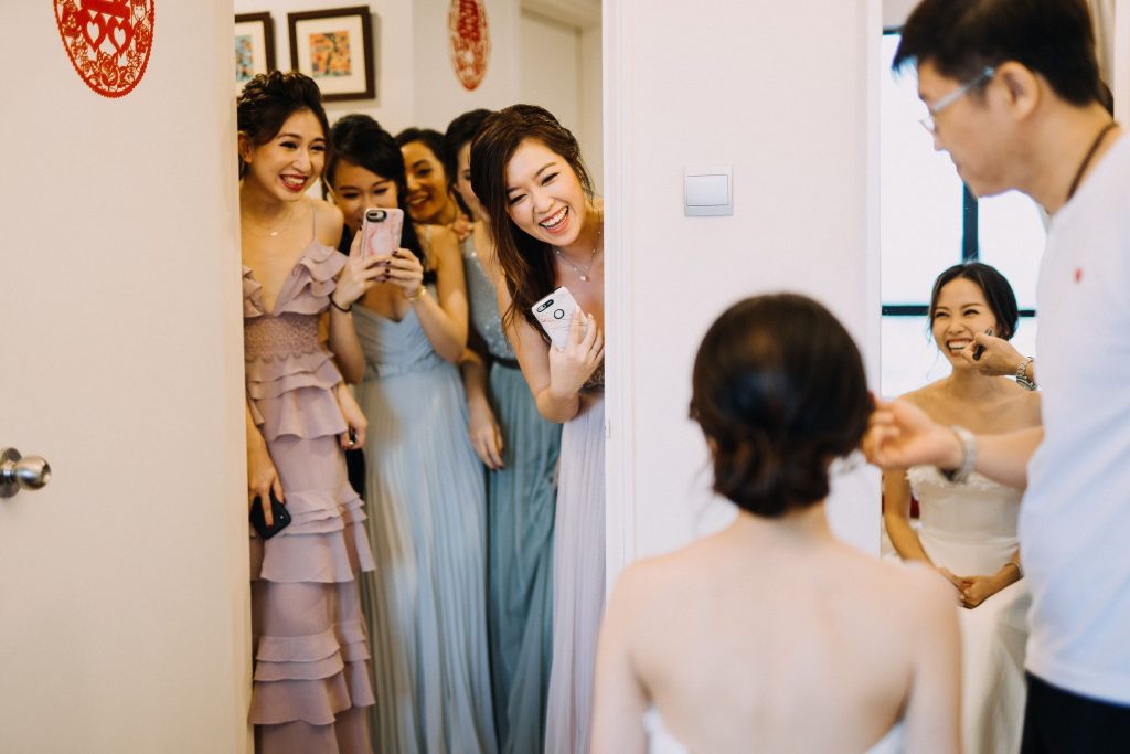 photo of bride getting ready and friends clicking her picture